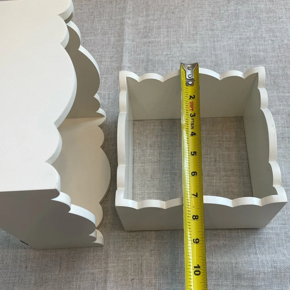 Two wall hanging white shadow boxes.